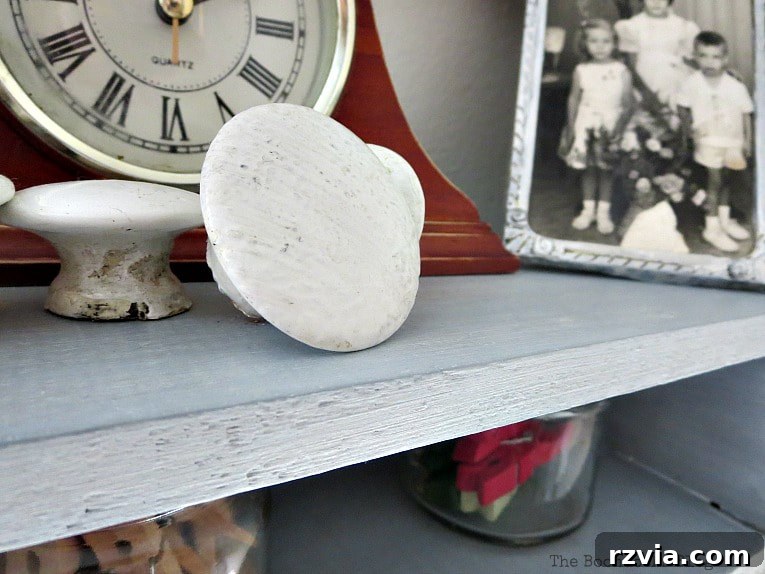 Decorated shelf with various objects, showcasing its new shimmering finish in a staged setting.