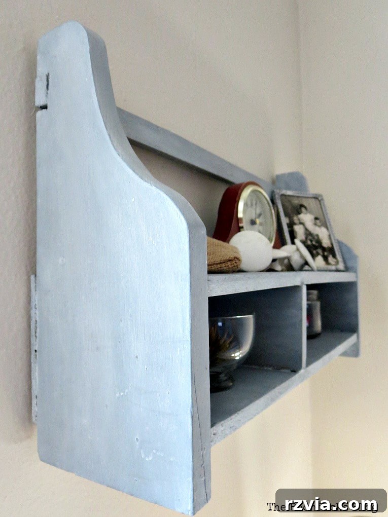 A stunning shot of the wall-mounted wood cubby shelf, showcasing its decorative wax, shine, shimmer, and upcycled charm, ready for its final placement.