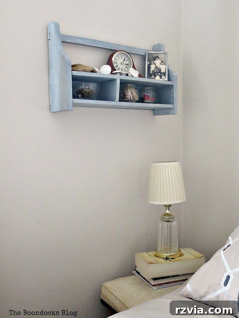 Another perspective of the freshly painted and shimmer-enhanced wall-mounted cubby shelf, symbolizing a successful upcycling project and charming bedroom addition.