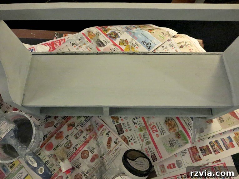 Freshly painted wall shelf with custom gray-blue milk paint, a key step in adding shimmer to a shelf.
