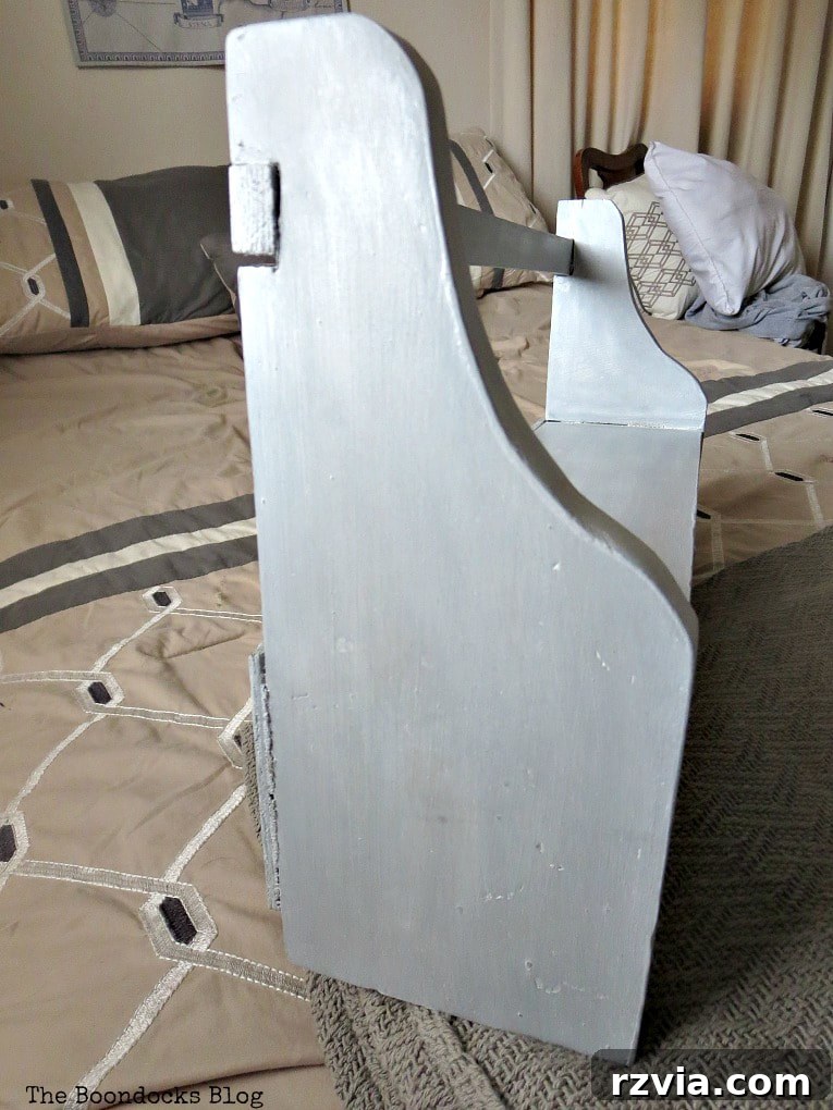 Side view of the finished wood shelf, revealing the subtle sheen from the decorative wax and the potential for added shimmer.