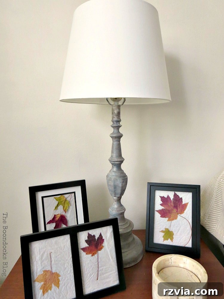 Give Your Lamp Base a High-End Stone Look 14 The faux stone painted lamp base resting on a wooden table, surrounded by decor including framed pictures of leaves, creating a cohesive and natural aesthetic in the living space. This image demonstrates how the lamp integrates with other home decor elements.