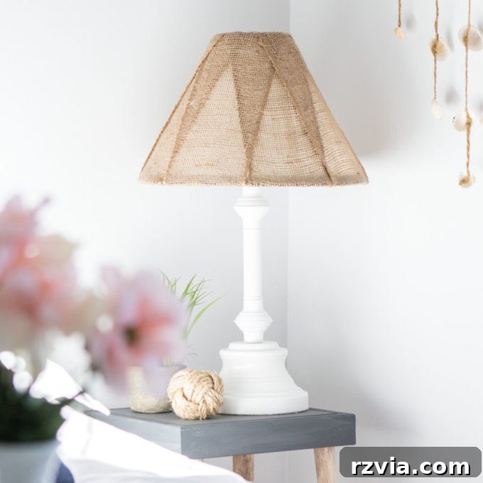 Give Your Lamp Base a High-End Stone Look 15 A chic nautical-themed white lamp with a textured burlap shade, exemplifying elegant lamp painting ideas. The lamp base is painted a crisp white, offering a fresh, coastal-inspired look suitable for various home decors.