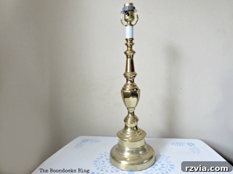 Give Your Lamp Base a High-End Stone Look 3 Before shot of the lamp base, showcasing its original glossy faux gold finish. The design is visible, but the color appears dated and out of style.