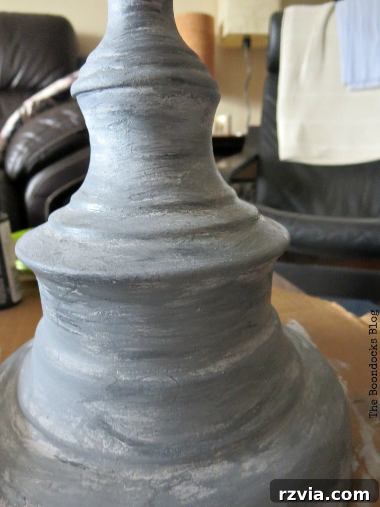 Give Your Lamp Base a High-End Stone Look 9 A detailed close-up of the finished lamp base, beautifully painted to resemble stone. The variegated grey tones and textured surface are clearly visible, illustrating the success of the faux finish technique.
