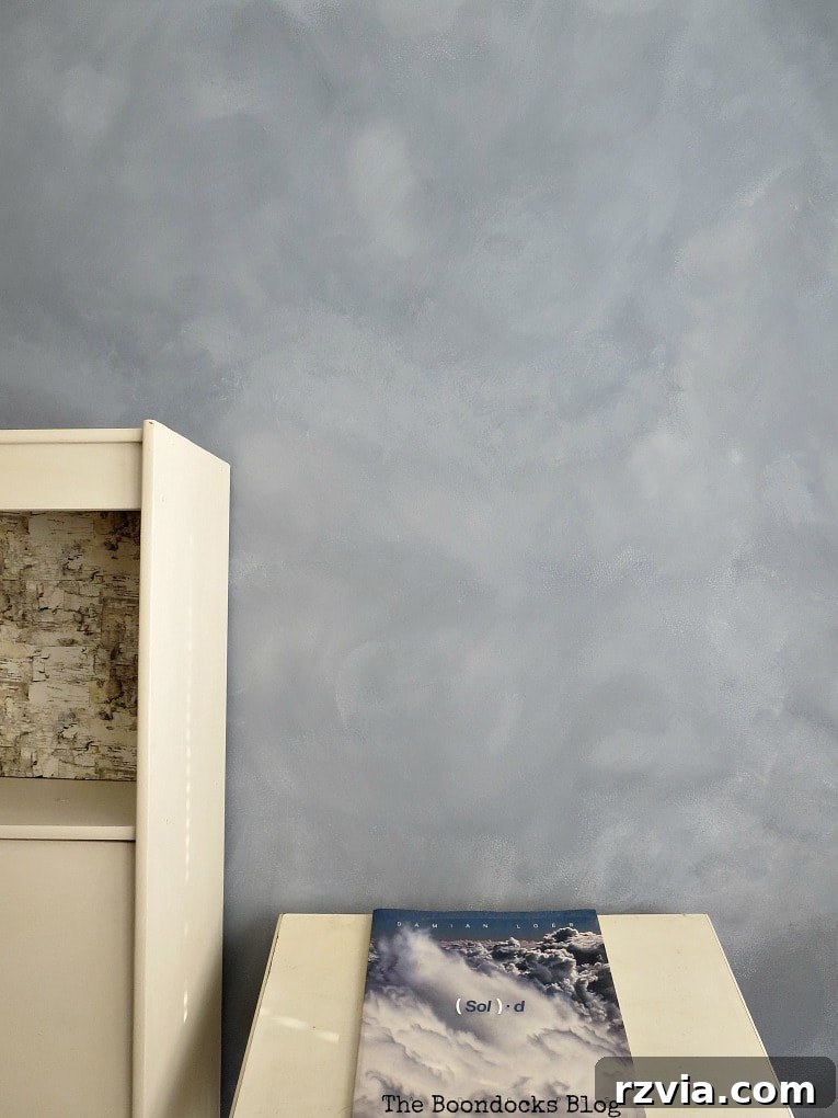 Create Your Own Dreamy Cloud Accent Wall 2 The finished accent wall showcasing a beautiful, ethereal cloud effect created with milk paint, sponges, and brushes.