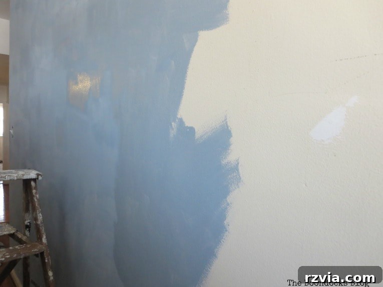 Create Your Own Dreamy Cloud Accent Wall 6 Close-up of the first coat of paint being applied to the wall, demonstrating early coverage.