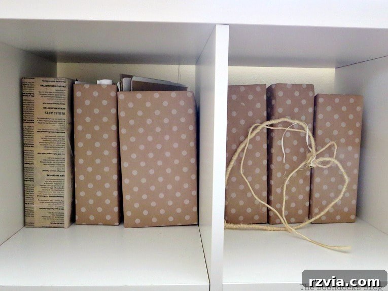 DIY Cardboard Desk Organizer 8 A collection of magazine files, neatly covered in coordinating gift wrap paper, ready for organized storage.