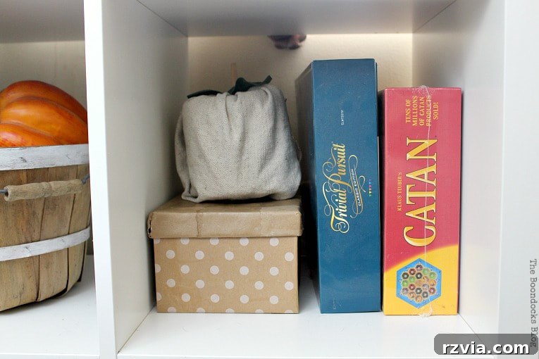 DIY Cardboard Desk Organizer 9 A shoebox, beautifully covered in gift wrap paper, sits next to an assortment of board games, providing discreet and stylish storage.