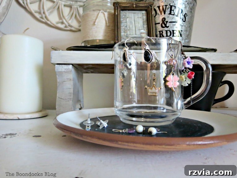 Jewel Your Furniture: Crystal Knobs for an Instant Upgrade 12 Decorative glass cup on dresser, stylishly holding drop earrings, matching the crystal knobs.