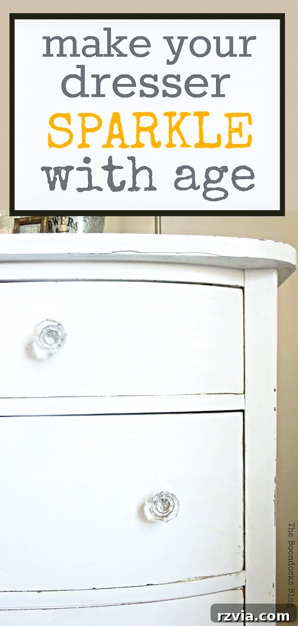 Jewel Your Furniture: Crystal Knobs for an Instant Upgrade 15 Elegant vertical shot of the completed white distressed vintage dresser with crystal knobs for bedroom styling.