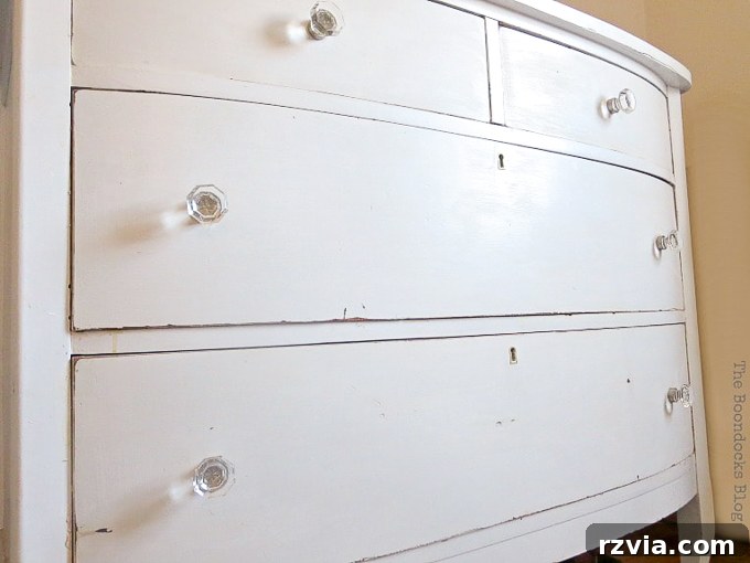 Jewel Your Furniture: Crystal Knobs for an Instant Upgrade 5 Vintage white distressed dresser adorned with crystal glass knobs, creating an elegant 'sparkle with age' aesthetic.