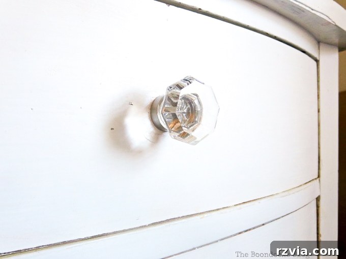 Jewel Your Furniture: Crystal Knobs for an Instant Upgrade 7 Crystal glass knob with a sleek nickel base, perfectly complementing a distressed white dresser.
