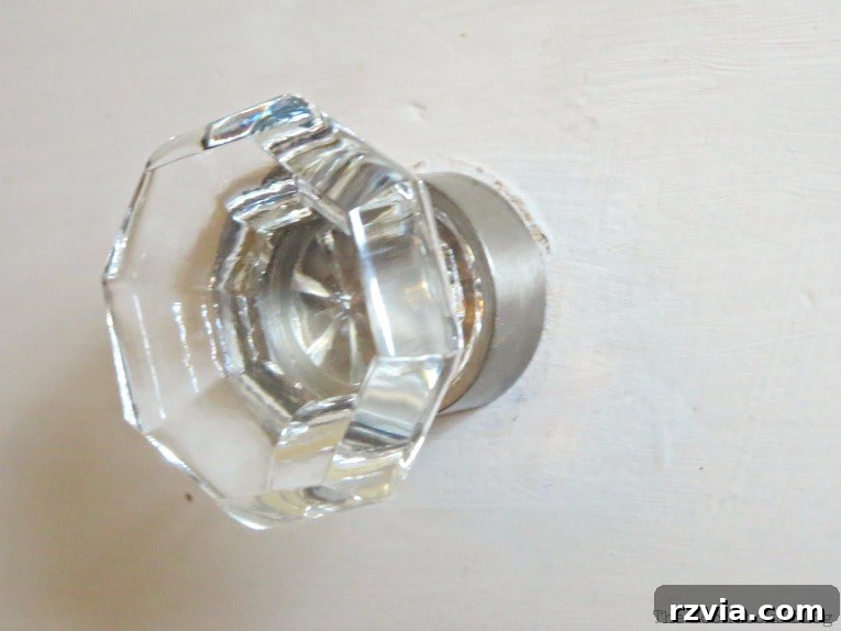 Jewel Your Furniture: Crystal Knobs for an Instant Upgrade 9 Close-up of a sparkling crystal glass knob and the distressed paint finish on the vintage dresser.