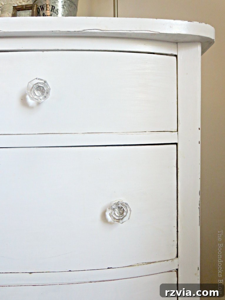 Jewel Your Furniture: Crystal Knobs for an Instant Upgrade 10 Full view of the distressed white vintage dresser with crystal glass knobs and subtle farmhouse charm.