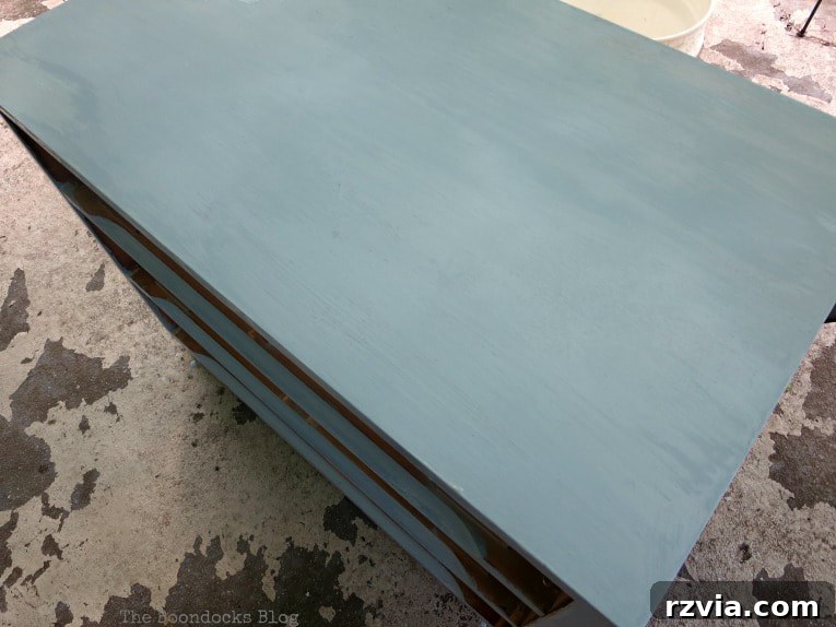 Mid Century Modern dresser fully painted in Slate milk paint, showcasing the deep blue finish after multiple coats.