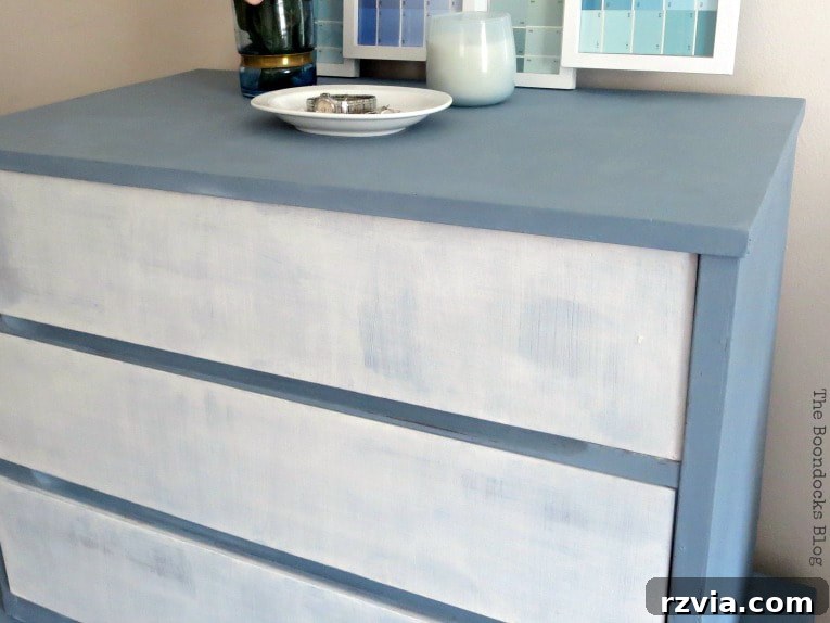 MCM dresser after being painted in white and slate and sealed with beeswax, showcasing its elegant, finished appearance.