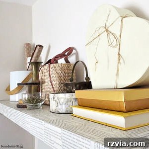 Decoupaged shelf with book pages for a unique look.