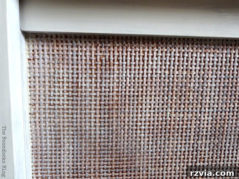 Detailed close-up of the MCM sideboard's rattan doors after dry-brushing and waxing, showing the softened paint and preserved texture.