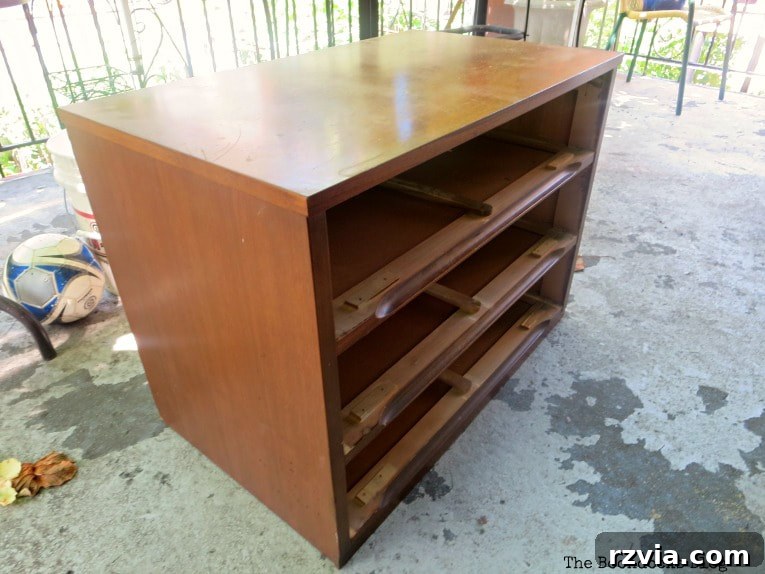 The Mid Century Modern dresser before its makeover, showing its original condition and solid structure.