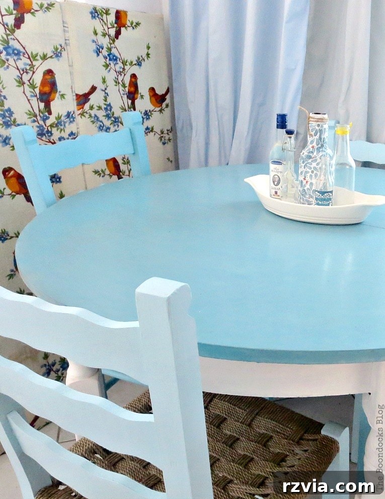 Revamp Your Wooden Chairs: Painting Made Easy 12 Full shot of the dining room with ombre blue chairs, beach table, and light-colored decor, illustrating how painted furniture brightens a small space with natural light.
