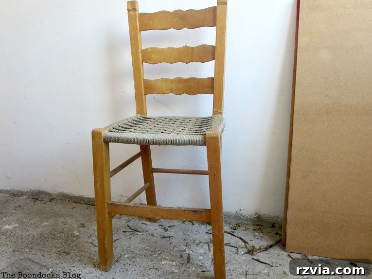 Revamp Your Wooden Chairs: Painting Made Easy 3 Close-up of a rustic wooden dining chair before painting, showcasing its natural wood grain and simple design, ready for a DIY chalk paint makeover.