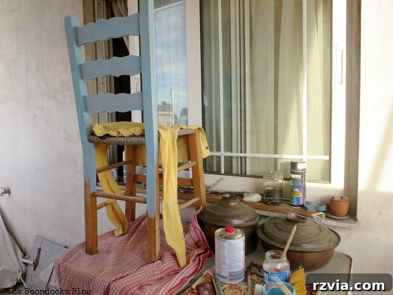 Revamp Your Wooden Chairs: Painting Made Easy 4 Wooden dining chair after the first coat of a rich blue chalk paint, showing initial coverage and preparation for a full DIY makeover.