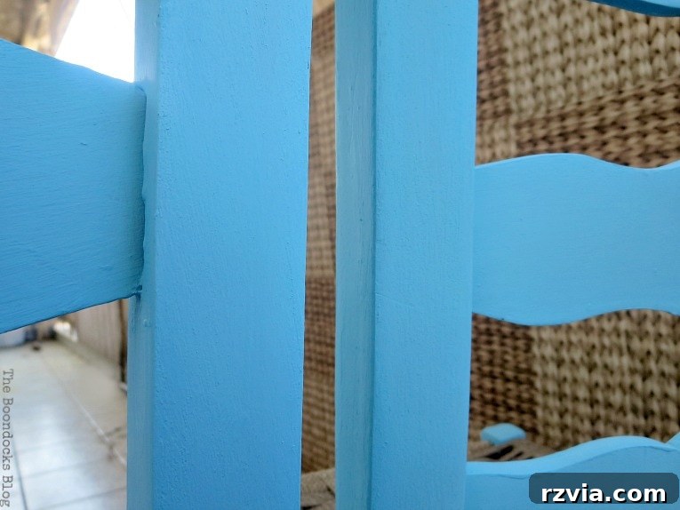 Revamp Your Wooden Chairs: Painting Made Easy 6 A wooden dining chair fully painted with two coats of vibrant blue chalk paint, showcasing the complete color transformation and readiness for sealing.