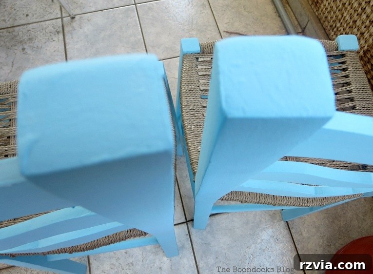 Revamp Your Wooden Chairs: Painting Made Easy 7 Two wooden dining chairs painted in a lighter shade of blue chalk paint, illustrating the progression of an ombre effect in a DIY furniture project.