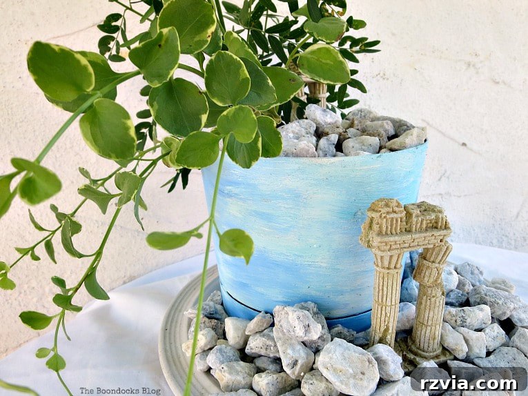 Seaside Style from Salvaged Treasures 17 A close-up view of the beachy planter vignette on a patio, showcasing its rustic beauty and bringing a piece of Greece to the outdoor space.