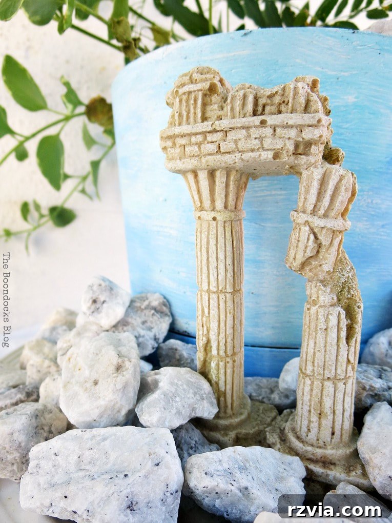 Seaside Style from Salvaged Treasures 18 An overhead view of the completed beachy planter vignette, highlighting the arrangement of the plant, pebbles, and 'ruins'.