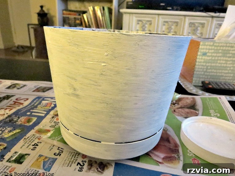 Seaside Style from Salvaged Treasures 9 Painting a plastic planter with white chalky finish paint to create a rustic, weathered base for the beach vignette.