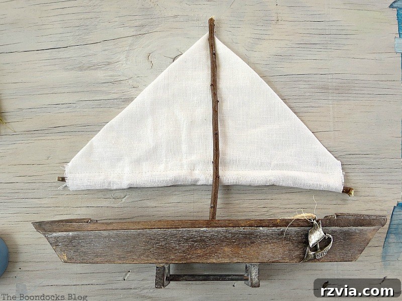Coastal Creations from Repurposed Finds 11 Handcrafted sails made from fabric and twigs, ready to be attached to the wooden boat