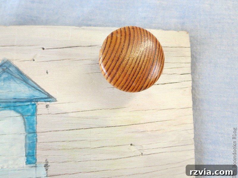 Coastal Creations from Repurposed Finds 13 A repurposed dresser knob securely screwed into the whitewashed plywood base for coastal art