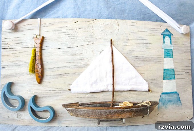 Coastal Creations from Repurposed Finds 15 Completed DIY seaside wall art featuring a boat, lighthouse, and fish, made from upcycled materials