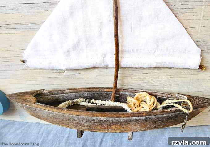 Coastal Creations from Repurposed Finds 16 Close-up detail of the inside of the wooden boat, showcasing its repurposed role in the art piece