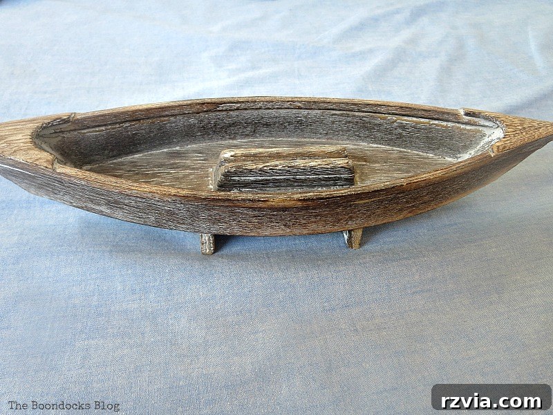 Coastal Creations from Repurposed Finds 10 A small wooden boat, previously part of a picture frame, repurposed for coastal decor