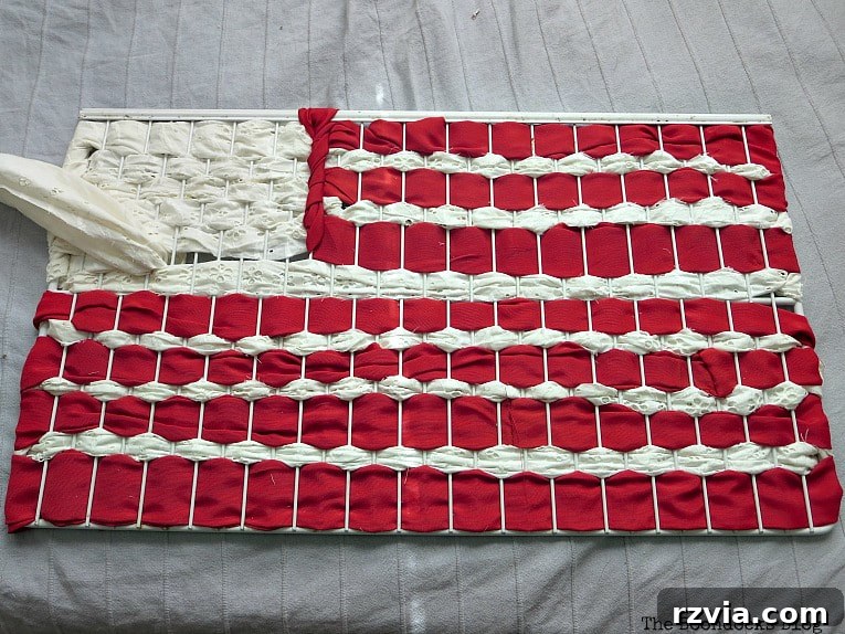 Simple Patriotic Fabric Art from Scraps 7 Wire rack with red and white fabric scraps woven to create flag stripes