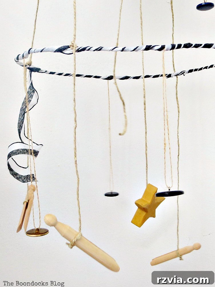 Beyond the Closet: Crafting Unique Mobiles from Wire Hangers 20 Mobile hanger with three tiers made with wire hangers, a wicker charger and twine, embellished with buttons, ribbon and a bouquet.