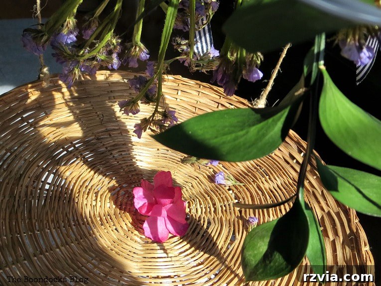 Beyond the Closet: Crafting Unique Mobiles from Wire Hangers 3 Close up of a wicker plate charger and flowers.