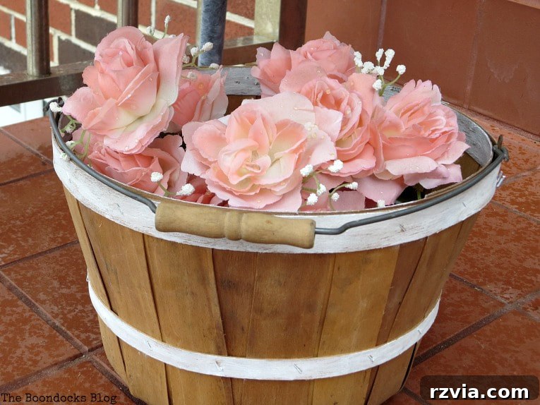 Rattan Revival: Creative Ideas for Your Damaged Chair 12 Close-up of the basket with faux flowers, adding a final charming touch to the outdoor decor.