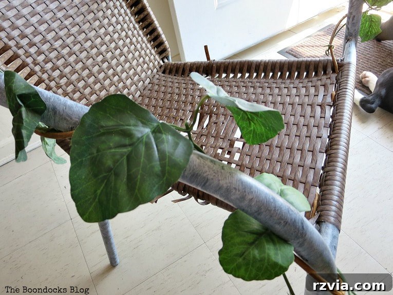 Rattan Revival: Creative Ideas for Your Damaged Chair 5 The painted metal frame of the rattan chair, now bright white, with faux vines wrapped around it for a softer look.