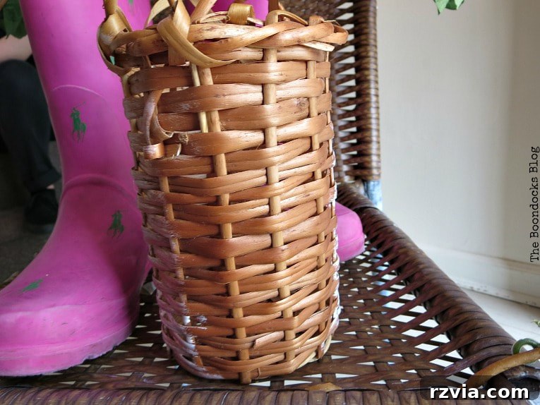 Rattan Revival: Creative Ideas for Your Damaged Chair 6 A repurposed wicker wine bottle holder, painted white, ready to become part of the vignette.