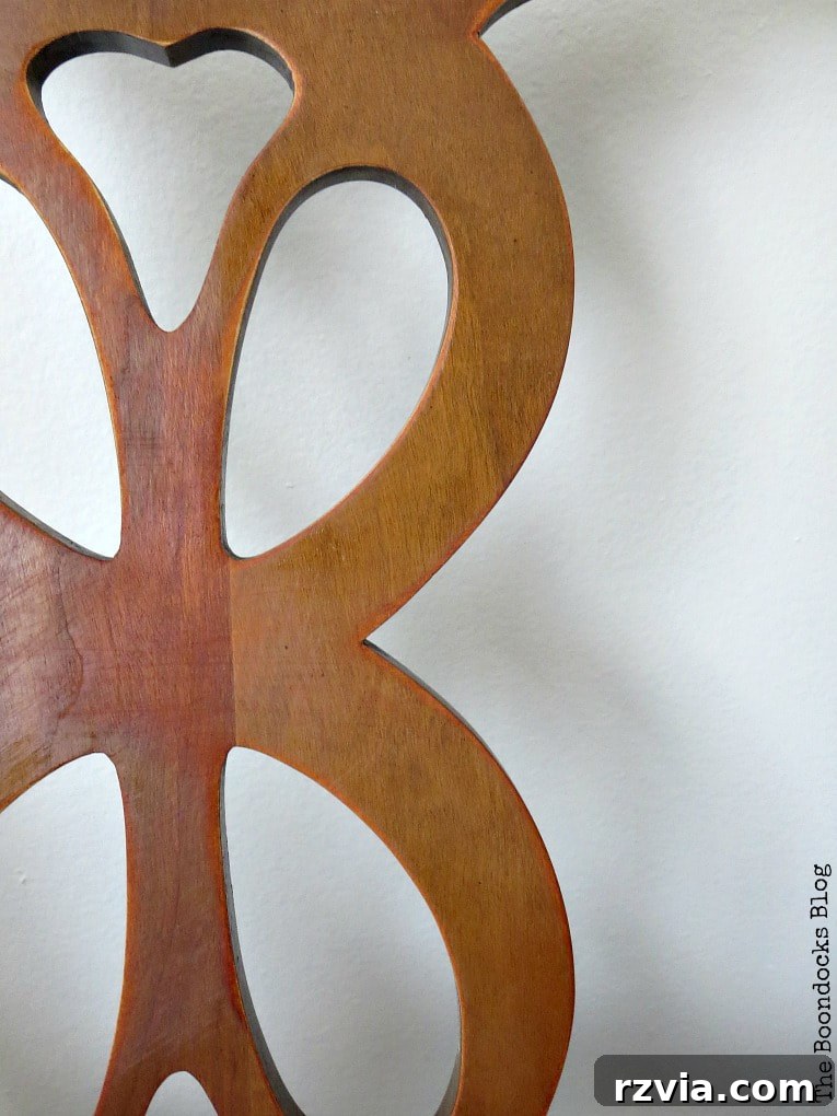 Close-up detail of the finished wood chair, highlighting the natural grain and distressed elements on the frame.