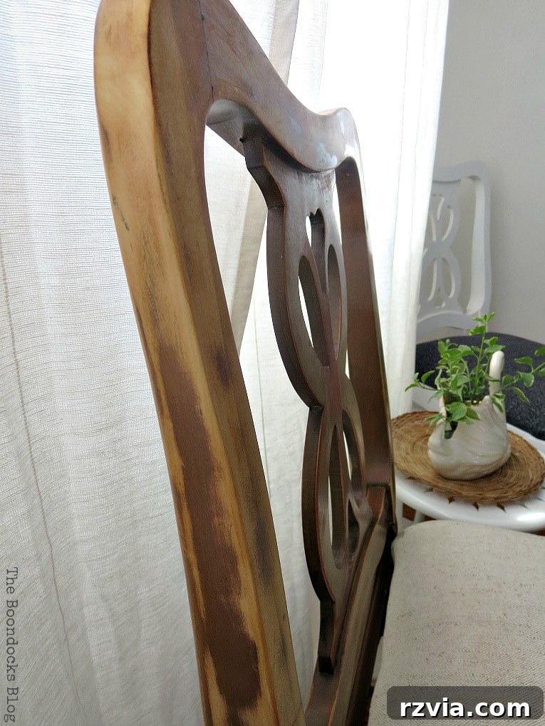 Side view of the finished wood chair, showcasing its elegant lines and the rich, natural wood finish from the makeover.