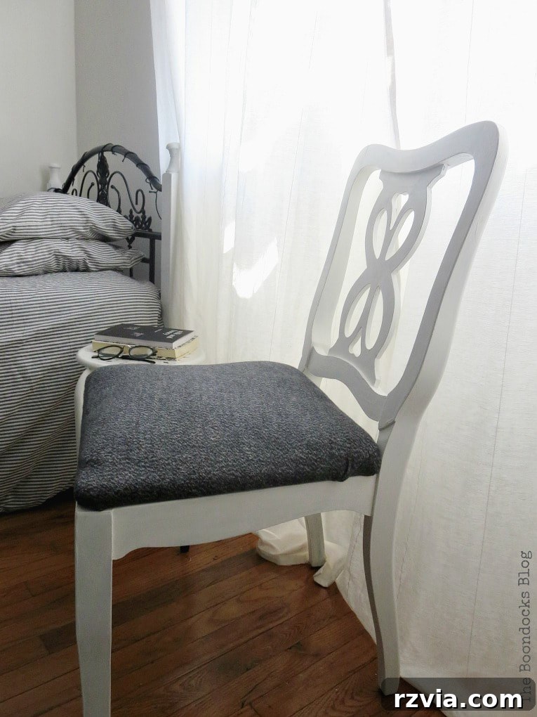 The white finished chair perfectly placed in the girls' black and white themed bedroom, showcasing its modern and cohesive look.