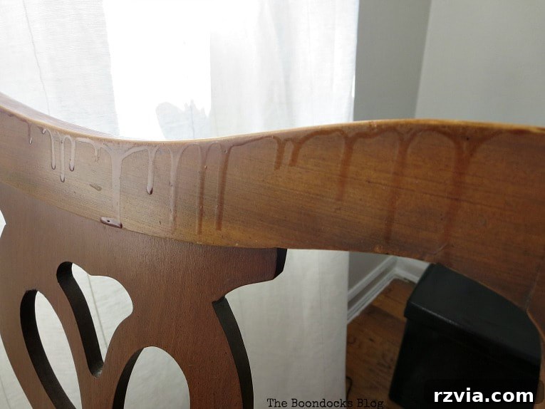 Close-up of dried stain drips on the chair frame, revealing the need for thorough sanding before the makeover.