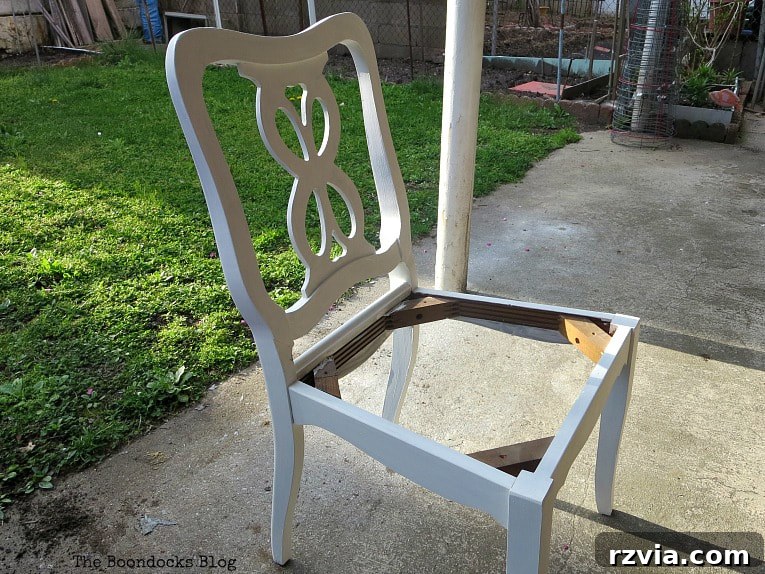 The chair painted in a pristine white with chalky finish paint, showcasing a smooth and modern aesthetic.