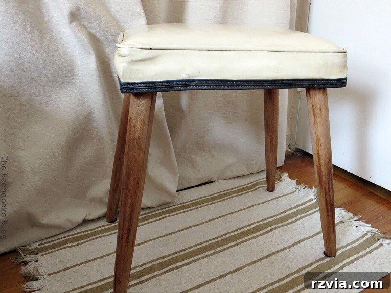 The fully restored Mid-Century Modern small bench, showcasing its stylish and elegant transformation.