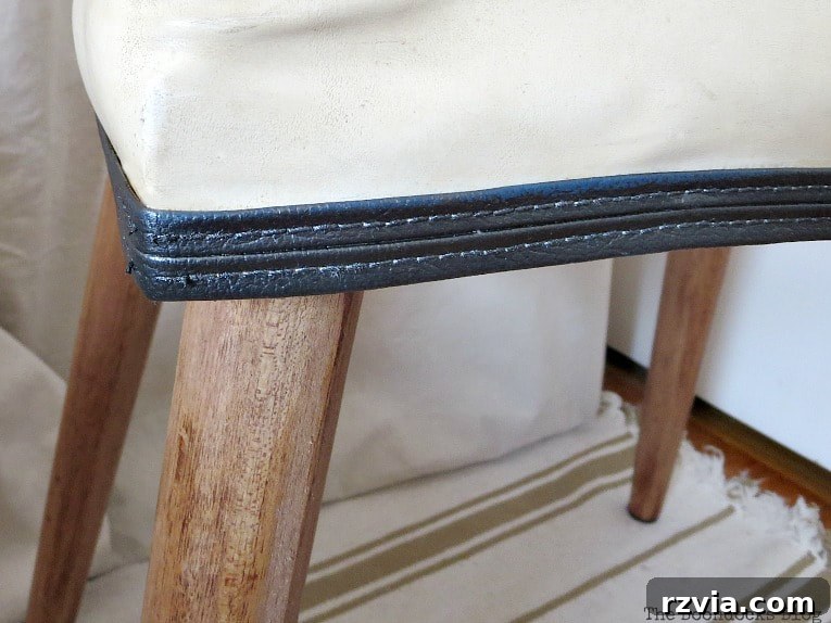 Detailed close-up of the freshly painted vinyl piping on the Mid-Century Modern bench, showcasing its smoky gray metallic finish.